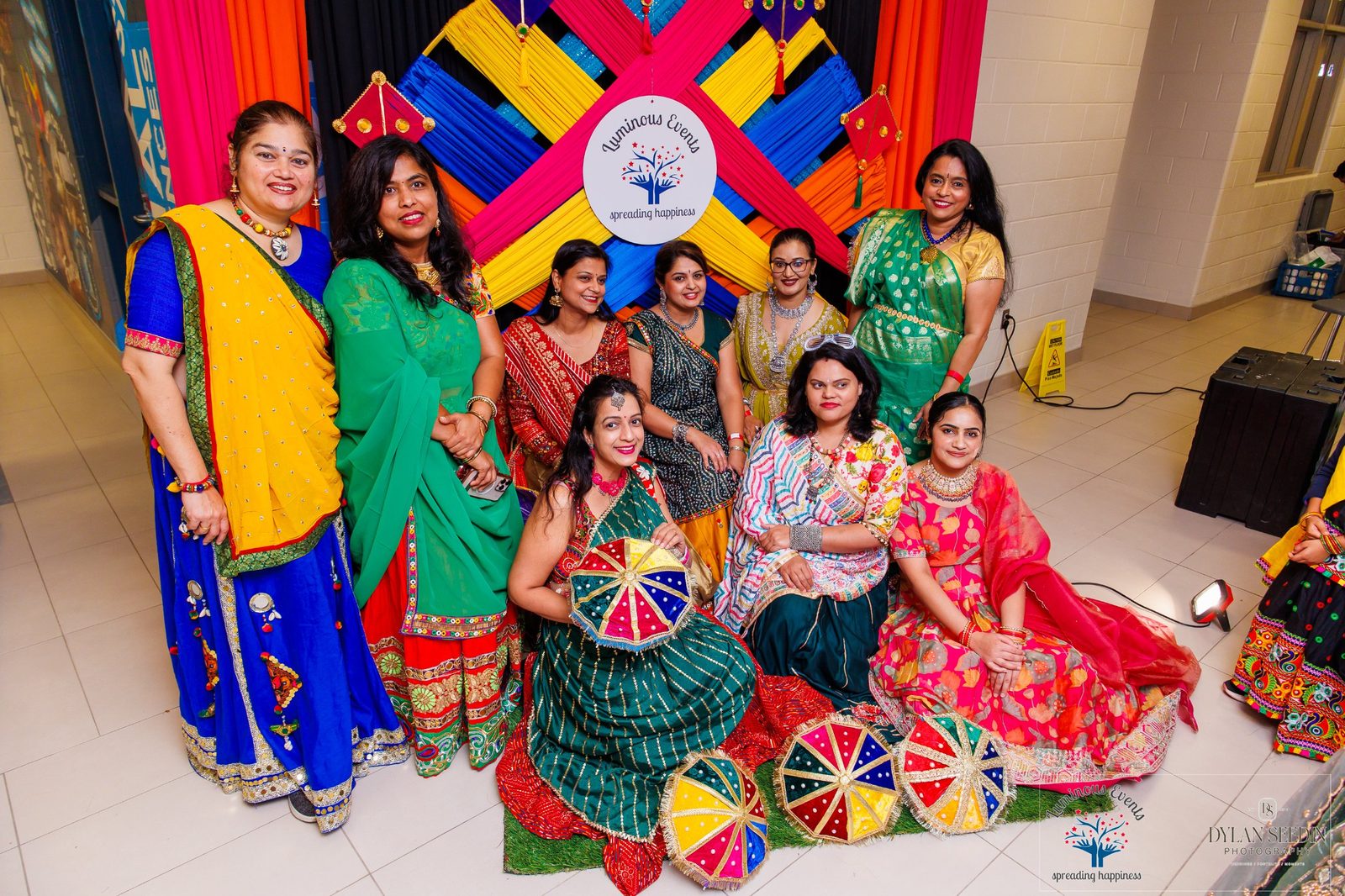 Guests posing with the Luminous Events backdrop